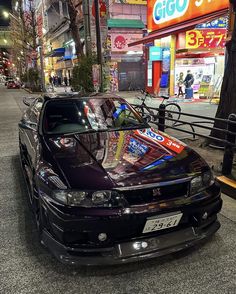 a black car parked on the side of a street