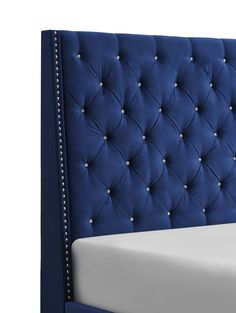 a blue headboard with white sheets and buttons