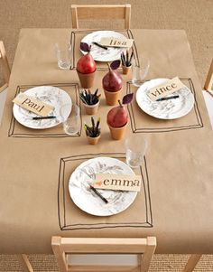 the table is set with plates and place settings