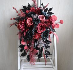 a bouquet of flowers sitting on top of a white chair