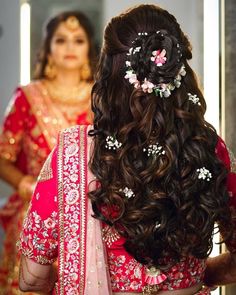 the back of a woman's head with flowers in her hair