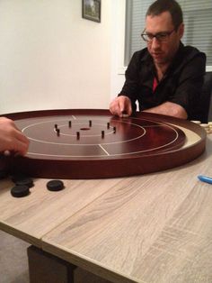 a man sitting at a table with a board game on it