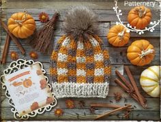 a knitted hat with pumpkins and other autumn decorations