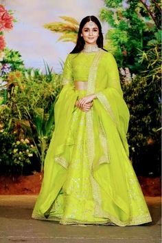 a woman in a bright green lehenga