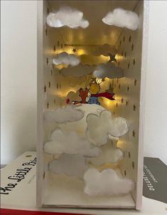 a cardboard box with some clouds in the shape of winnie the pooh on it