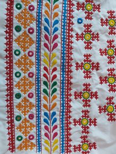 an embroidered cloth with different colors and designs on the side, including flowers and leaves