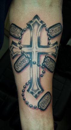 a cross with two names on it and some beads around the edges that say jesus