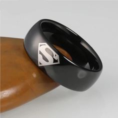 Shop the Stainless Steel Superhero Ring because the real superhero is you. Distinguish your style with these gorgeous Superhero ring for men. It is a geometric design stainless steel ring that is uniquely finished giving it an elegant look and feel. They make great gift items for the special men in your life be it husband, boyfriend, father, brother, or, any other significant male in your life to whom you want to show love and honor. The ring are available in a wide range of ring sizes. Choose y Superhero Ring, Superman Ring, Superhero Rings, Steel Superman, Casual Rings, Black Stone Ring, Perfume Scents, Show Love, Stylish Rings