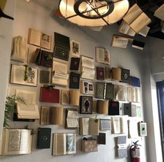 many books are hanging on the wall in this room with a chandelier above them