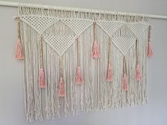 macrame wall hanging with pink tassels