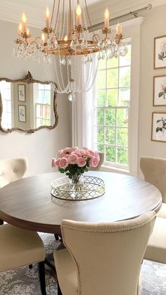 a dining room table with chairs and a chandelier