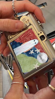 a person holding a cell phone in their hand with an american flag design on it