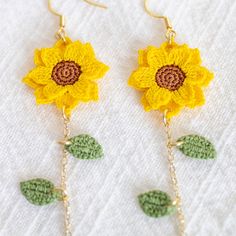 crocheted sunflower earrings with green leaves