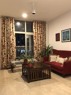 a living room with two couches and a coffee table in front of a window