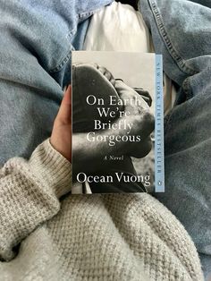 the book on earth we're briefly gorgeous by ocean vuong is being held up