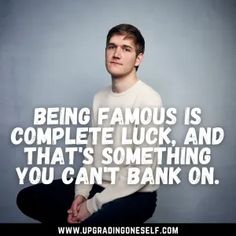 a man is sitting on the floor with his hands in his pockets and has a quote about being famous