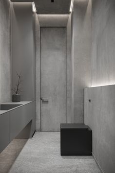 an empty bathroom with concrete walls and flooring