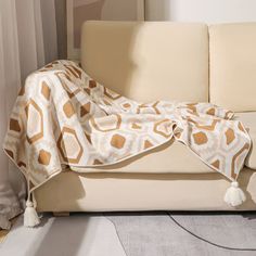 a couch with a blanket draped over it