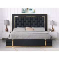 a bed with black and gold trimmings on the headboard is shown in this image