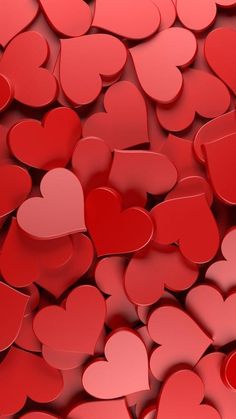 many red hearts are arranged in the shape of heart shapes, as if they were floating or floating on top of each other