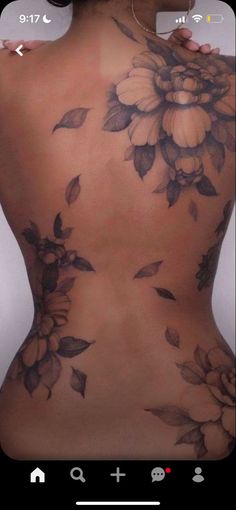 the back of a woman's body with flowers on it