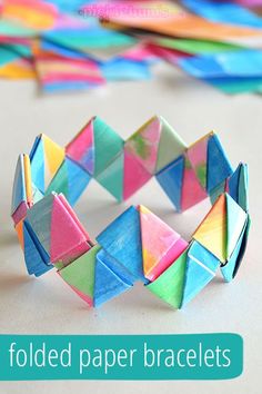 folded paper bracelets with text overlay that says folded paper bracelets on it