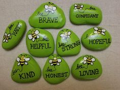 green painted rocks with sayings and bees on them that read, be brave, he is