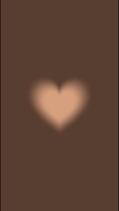 the shadow of a heart on a brown background