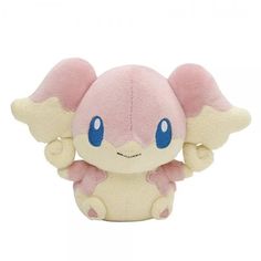 a small stuffed animal with blue eyes and pink ears, sitting in front of a white background