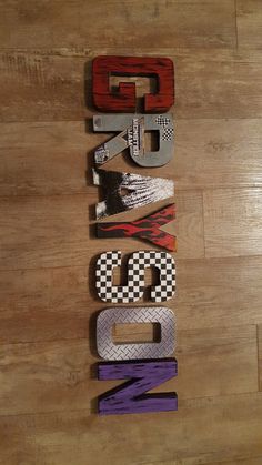 the letters are made out of wood and have different designs on them that spell out words