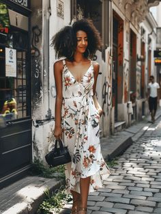 Strolling through the cobblestone streets, the casual elegance of a white maxi dress adorned with delicate floral prints catches the eye. This dress features a wrap-around design, enhancing the silhouette with its tie-waist detail. Paired with tan gladiator sandals and a simple black handbag, the outfit is a perfect blend of comfort and chic style. The casual simplicity of this attire is ideal for a day out in the city or a laid-back brunch with friends. Tan Gladiator Sandals, Cobblestone Streets