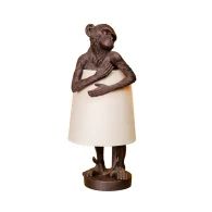 a monkey lamp with a white shade on it's head and arms folded up