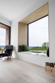 a living room filled with furniture and lots of window sills on top of wooden floors