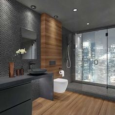 a bathroom with a toilet, sink, and shower stall in it's center