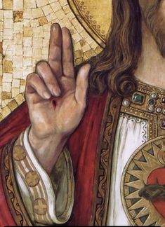 a close up of a painting of jesus holding his hand in front of the camera