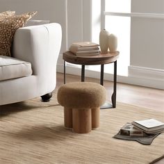 a living room with a white couch and coffee table on the floor next to it