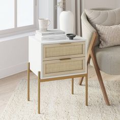 a white table with two drawers and a chair in front of it, next to a window