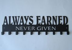 there is a metal sign that says, always earned never given