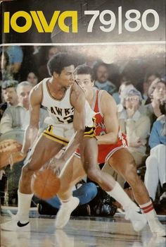 a book with an image of two basketball players on the cover and people watching from the sidelines