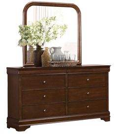 a dresser with a mirror and vase on top