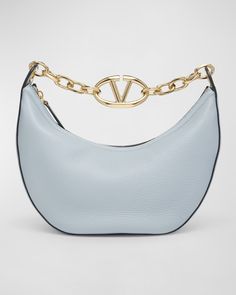 Valentino Garavani moon hobo bag in smooth calfskin leather and metal    VLOGO chain top handle     Detachable crossbody strap    Can be worn as a top handle, shoulder, or crossbody bag     Zip top closure     Approx. 5.1"H x 10.6"W x 4.3"D    Made in Italy Chain Top, Hobo Handbags, Shades Of Red, Zip Top, Crossbody Strap, Valentino Garavani, Hobo Bag, Top Handle, Calf Skin