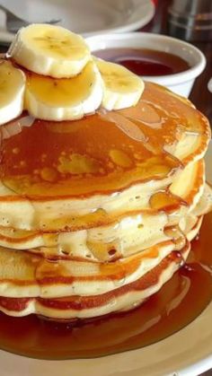 pancakes with bananas and syrup on a plate