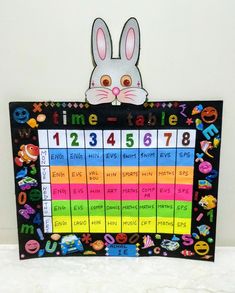 a sign with an image of a rabbit on it and the words time table written in different colors