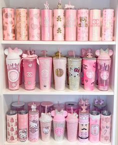 the shelves are filled with many different types of cups and tumblers in pink colors