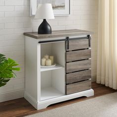 a white table with drawers and a lamp