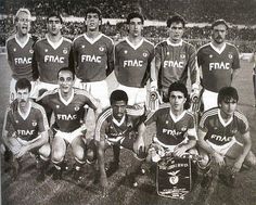 a group of men standing next to each other on a soccer field