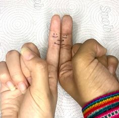 two hands with fingers that have small letters on them