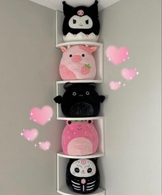 three shelves with stuffed animals and hearts on them