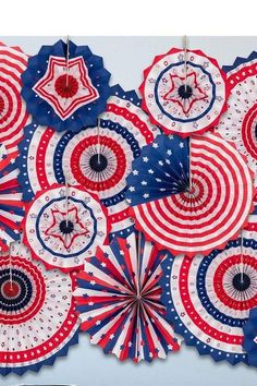 several red, white and blue paper fans hanging from strings