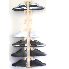 the shoe rack is made out of wood and has five pairs of shoes on it